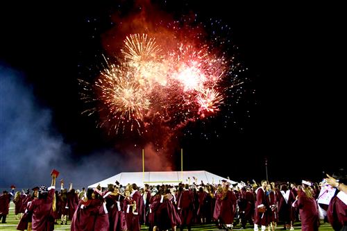 Fireworks in the sky, graduating students celebrating 