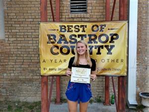 Picture of Lindsley holding award 