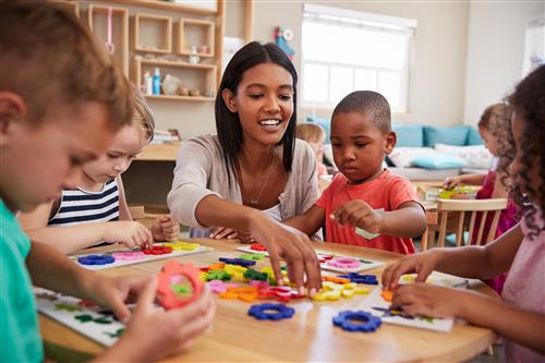 Photo of teacher with young children 