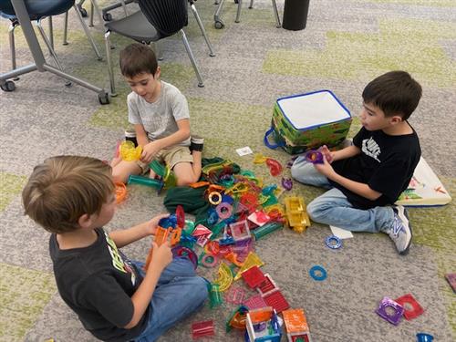 Students using magnatiles